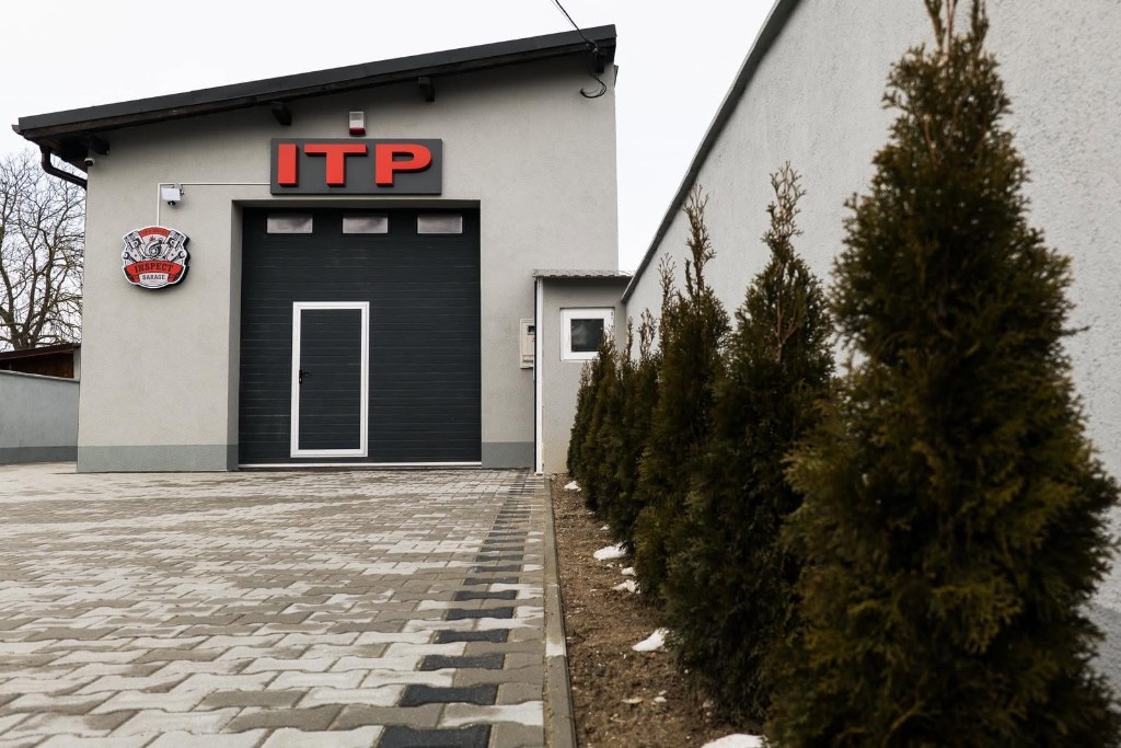 Exterior modern al garajului cu ușă sectională și semnalizare ITP